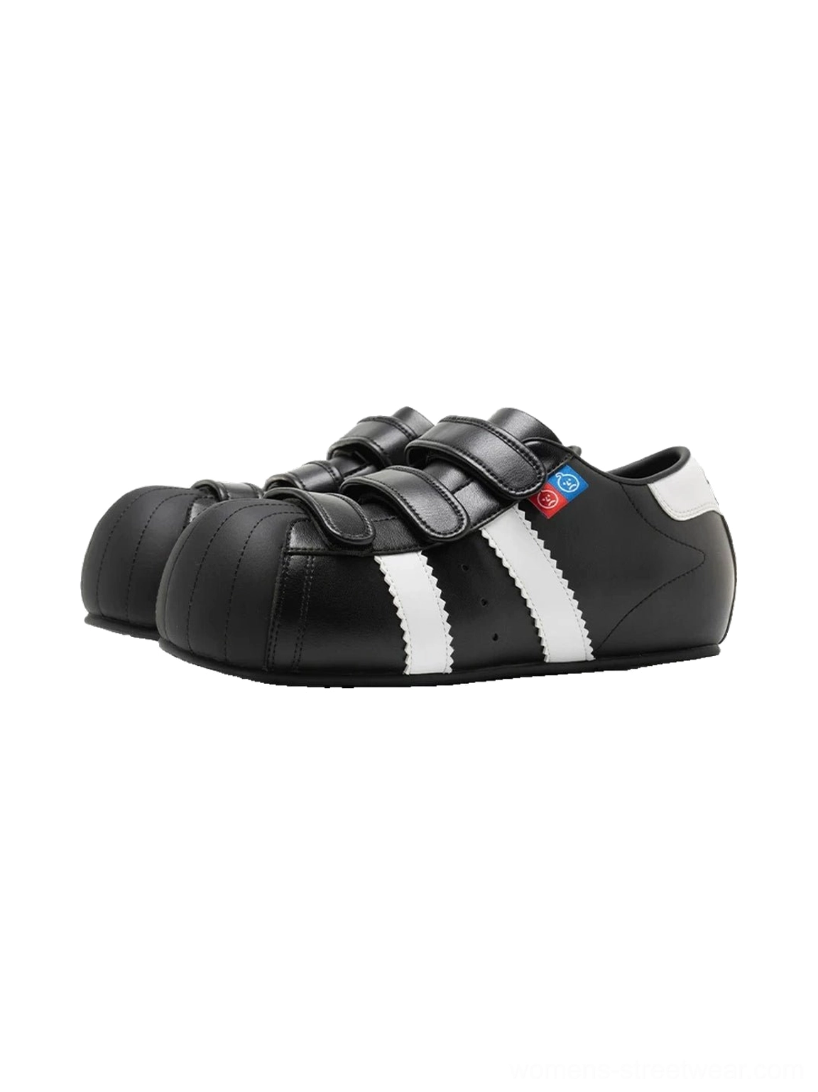 Low-top shell toe sneakers with adjustable hook-and-loop straps, contrast stripes, and discreet hidden lift