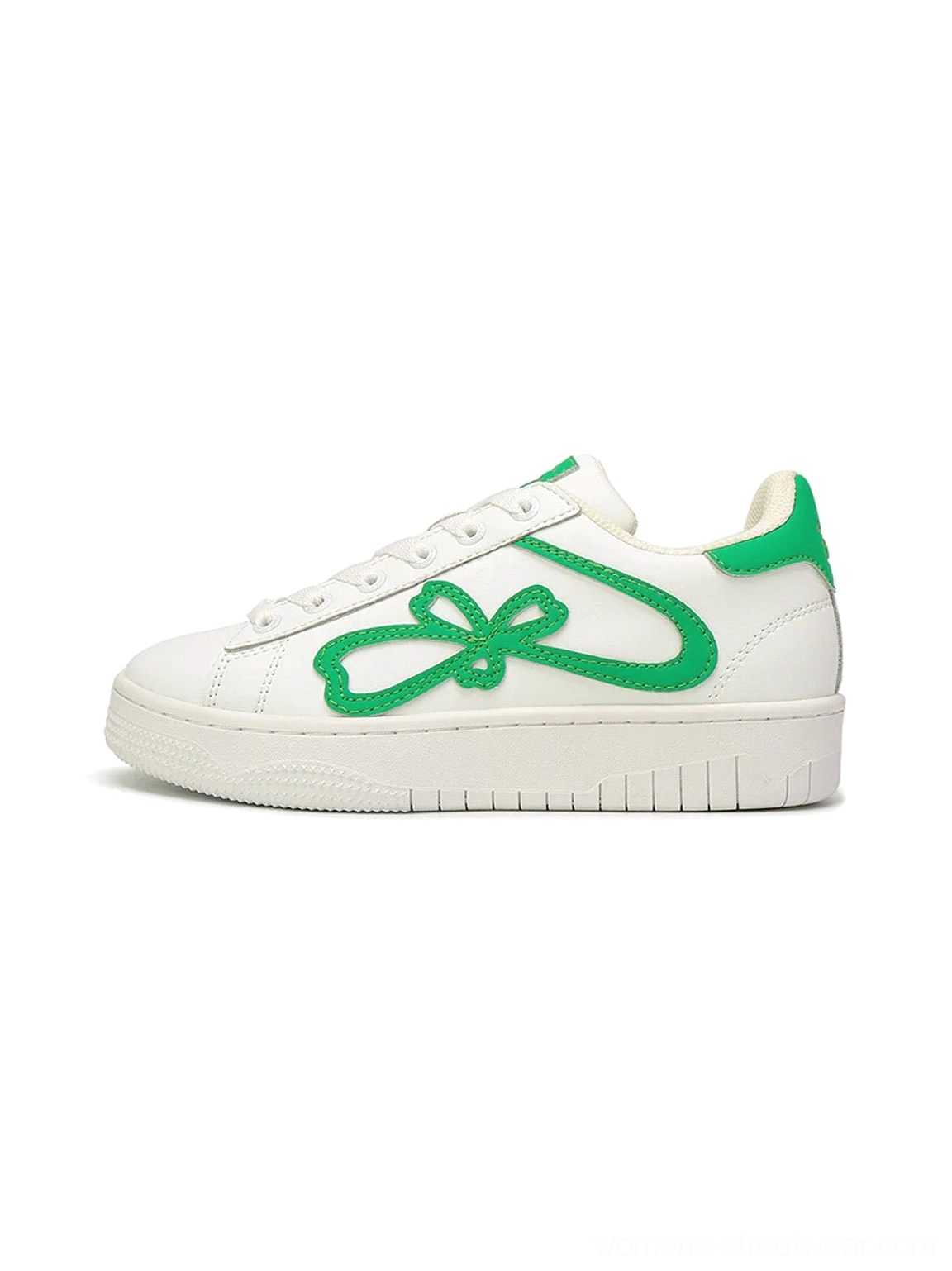 Green and white lucky clover chunky platform sneakers shown from the side with clover bow detail and textured rubber sole
