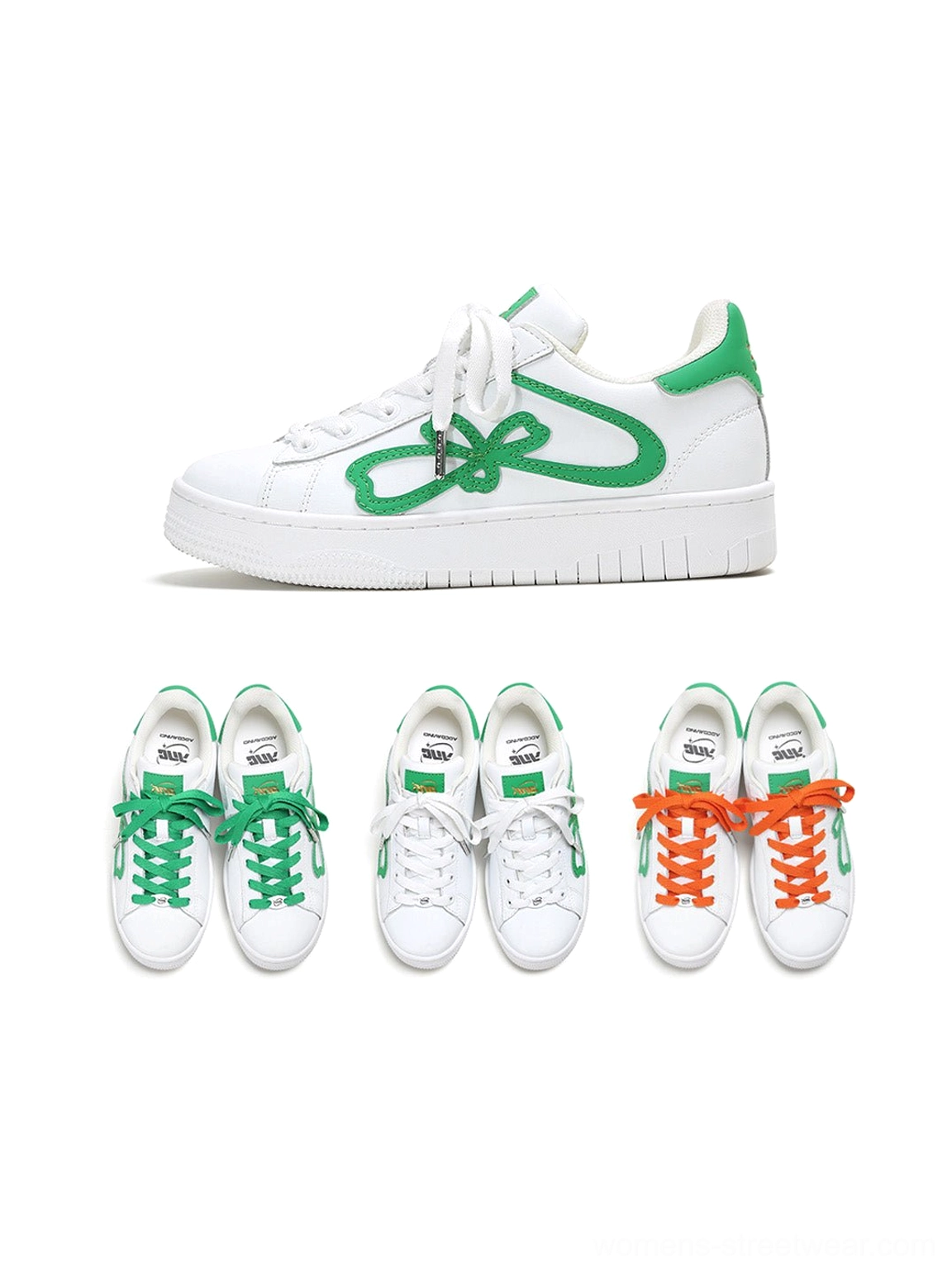 White lucky clover chunky platform sneakers displayed with green and orange replacement shoelaces