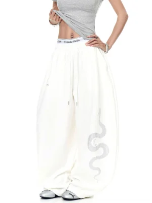 Off-white Lunar Serpent oversized wide-leg fleece sweatpants with serpent thigh graphic, elastic drawstring waistband, and baggy Y2K streetwear silhouette