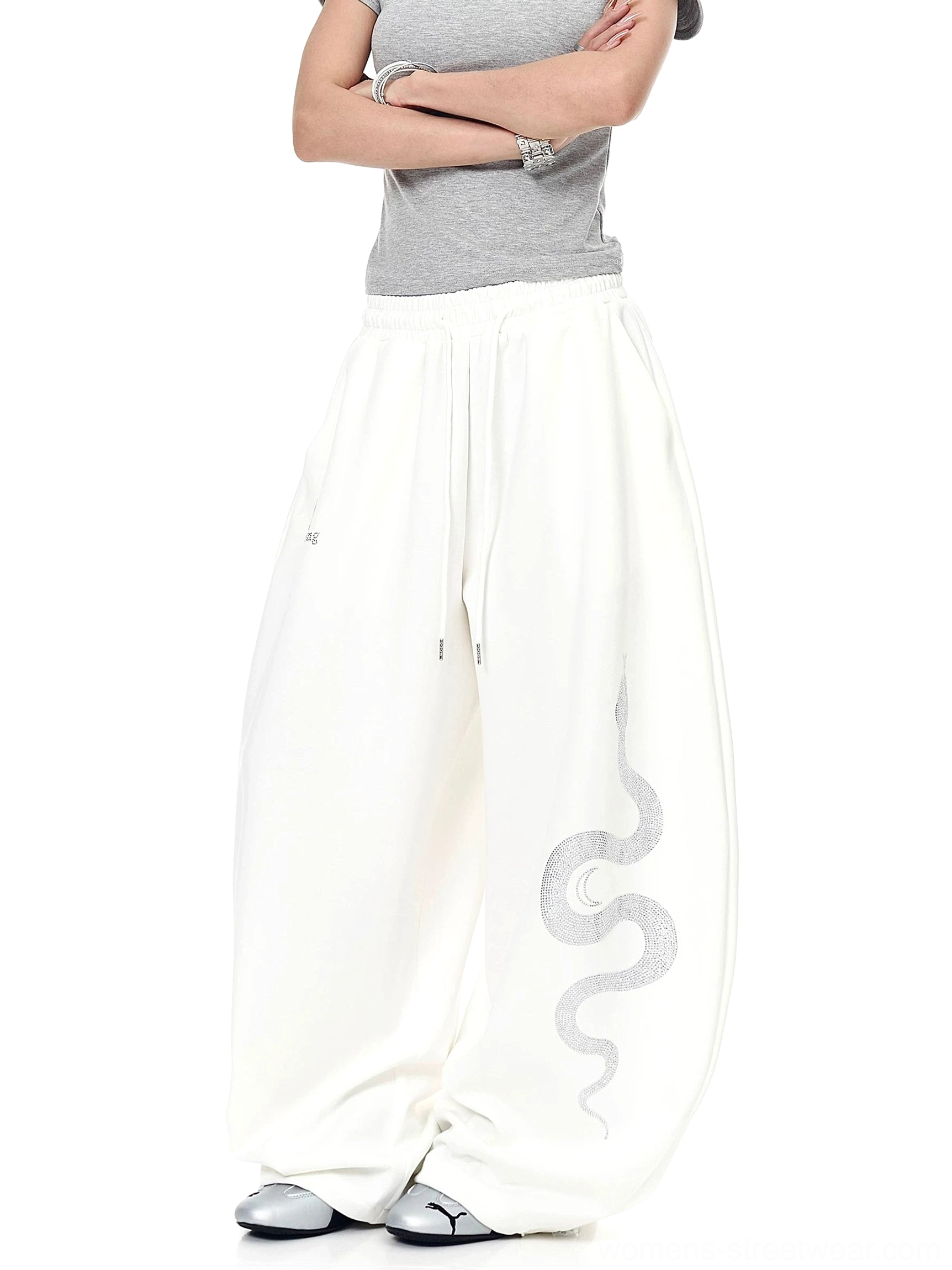 Off-white Lunar Serpent baggy sweatpants highlighting the elastic drawstring waistband, oversized fit, and thigh graphic for Y2K streetwear