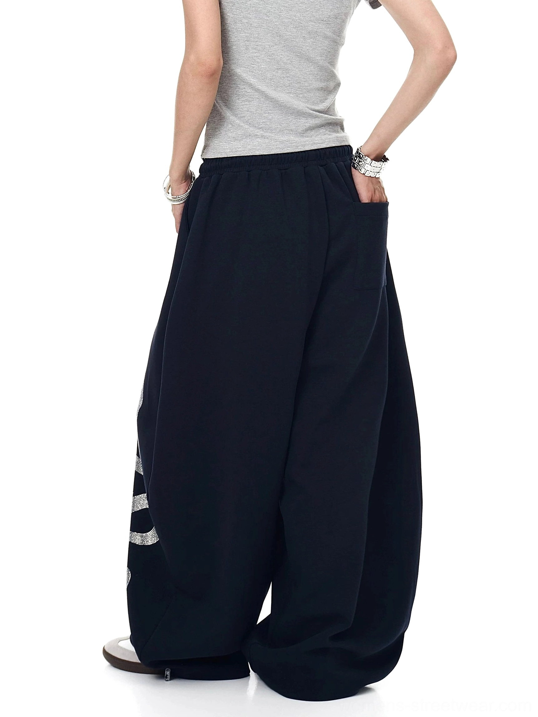 Lunar Serpent wide-leg fleece sweatpants in oversized Y2K streetwear style with relaxed proportions, soft cotton blend, and statement silhouette