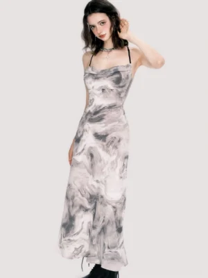 Three-quarter view of marble print slip maxi dress with fitted waist flowing floor-length skirt and delicate black straps