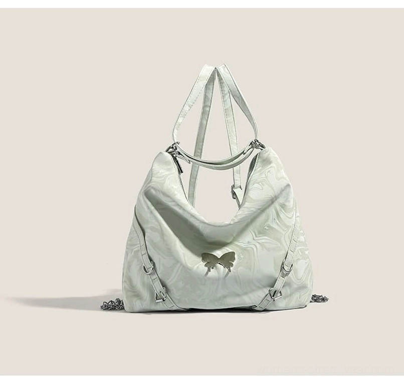Mint green marbled butterfly hobo bag back angled view showing shoulder handle and adjustable side straps