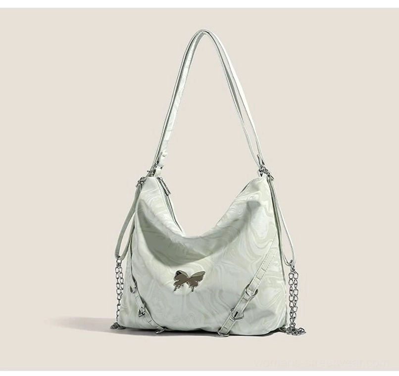 Mint green Y2K butterfly chain hobo shoulder bag front view with glossy marbled PU finish