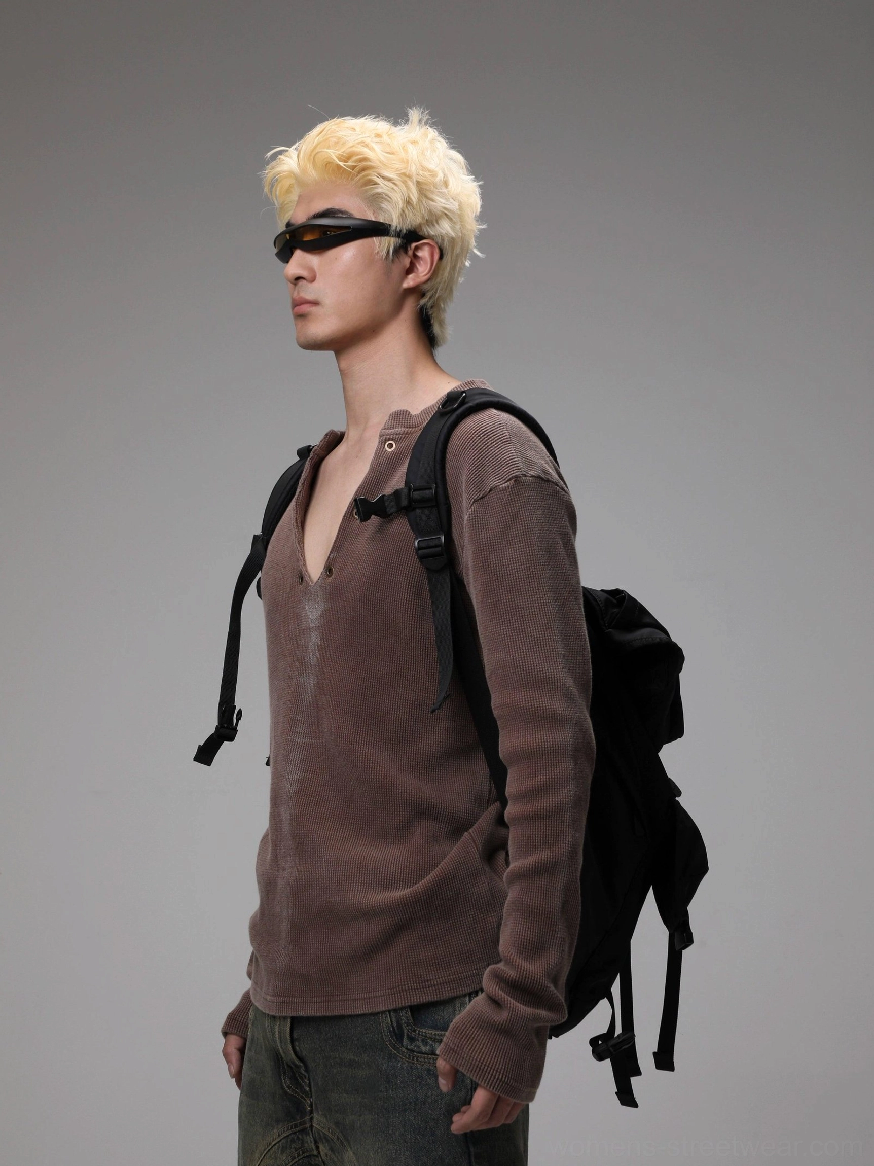 Side view of maroon distressed textured Henley knit sweater with long sleeves and relaxed streetwear styling