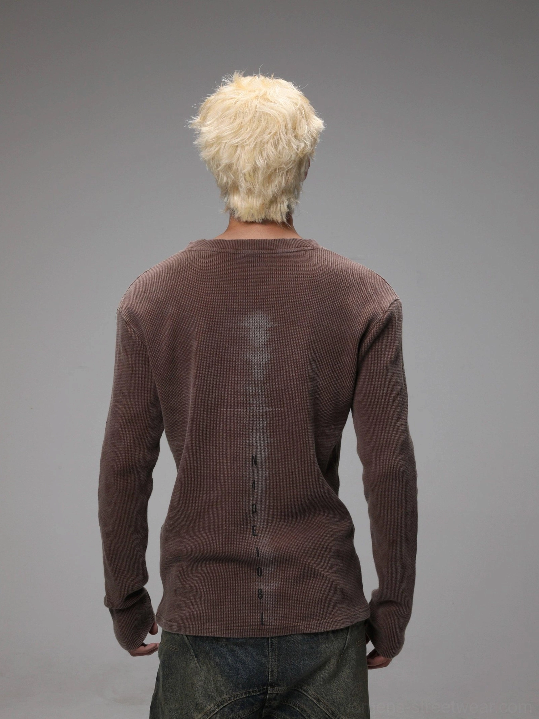 Back view of maroon textured knit sweater showing faded washed detail and fitted long sleeve cuffs