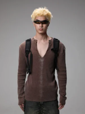 Maroon washed Henley knit sweater styled on a model with dark jeans, sunglasses, and backpack in a Seoul streetwear outfit