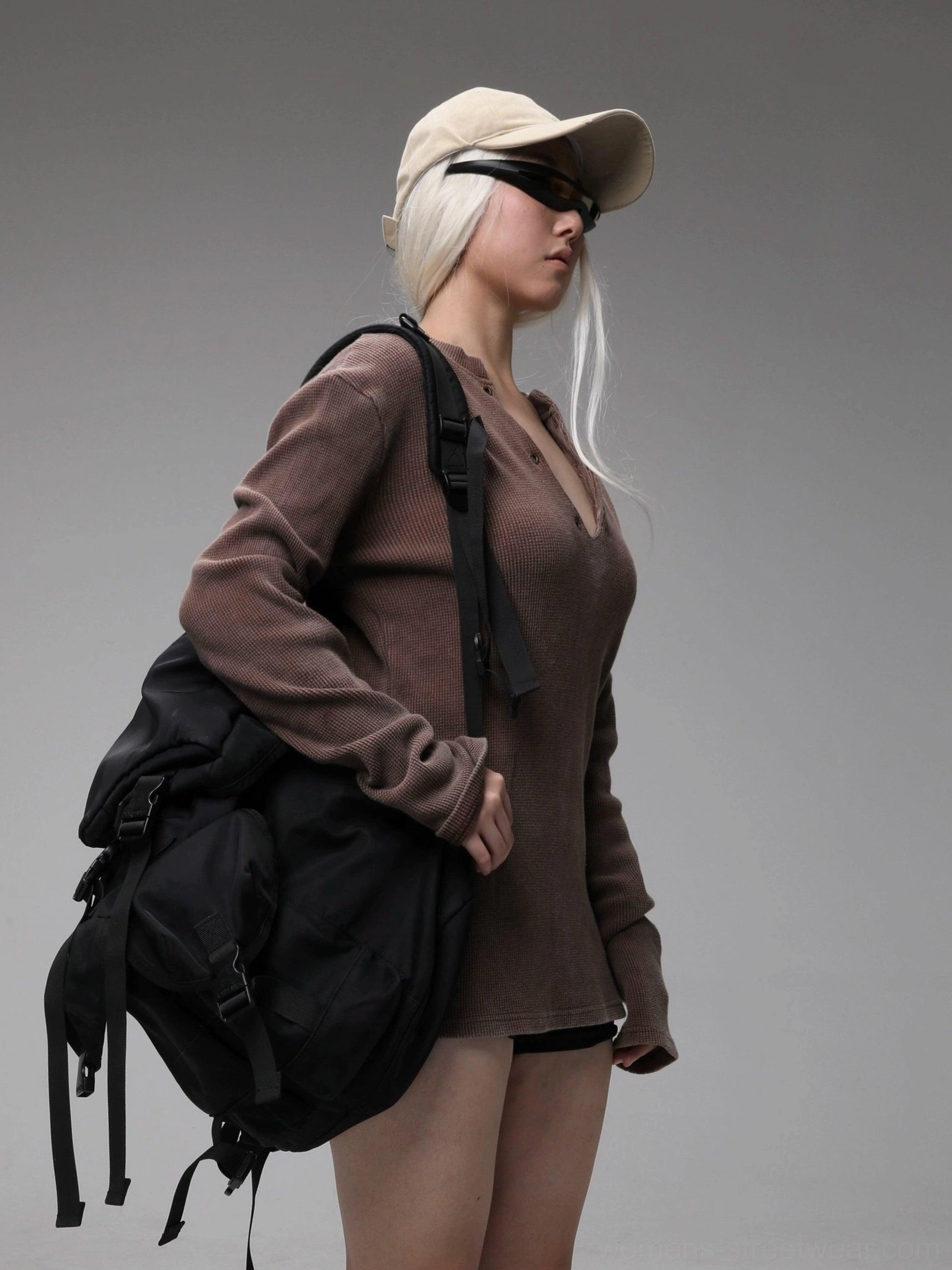 Oversized styling view of maroon washed buttoned V-neck Henley knit top with cap and backpack