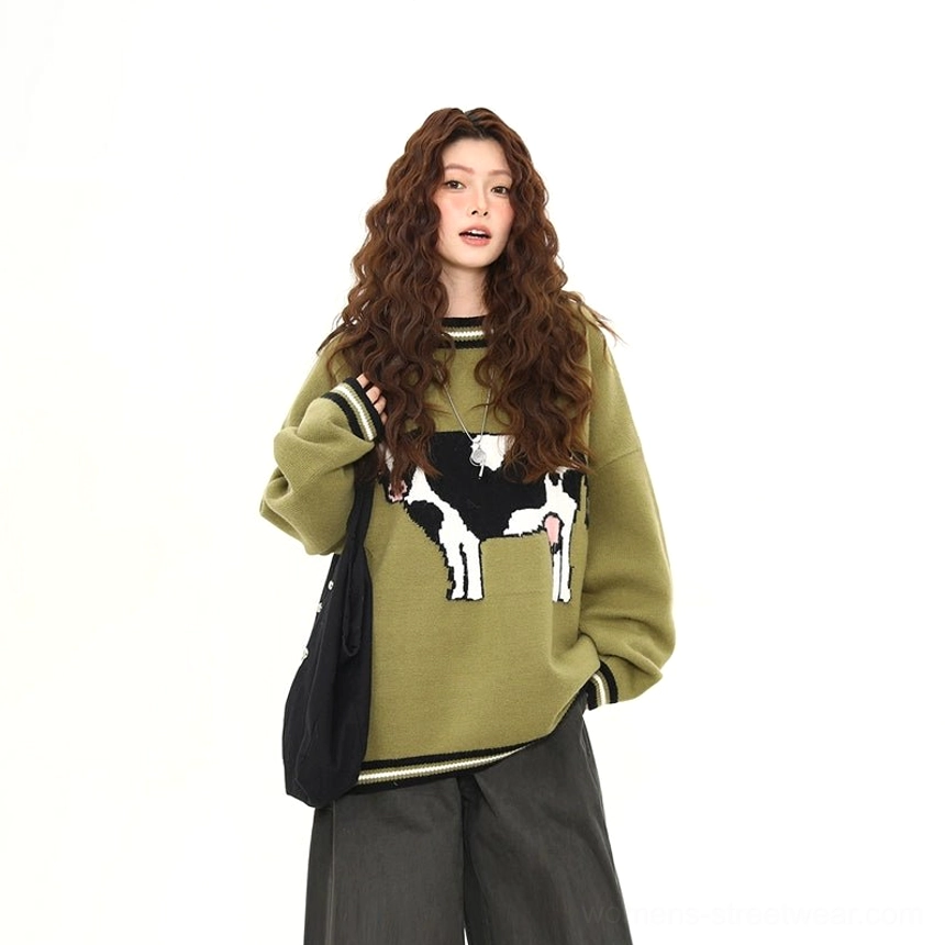 Matcha green cow jacquard oversized sweater styled with black wide leg trousers and canvas tote bag