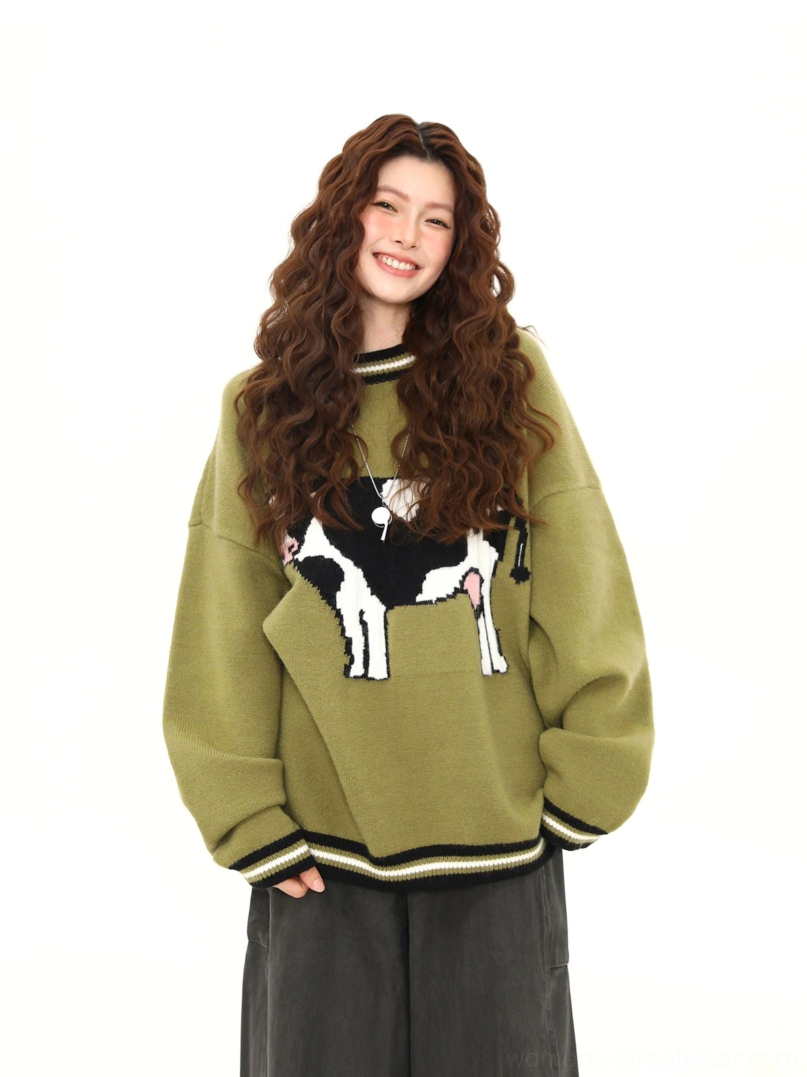 Matcha green oversized cow print knit sweater front view with contrast striped cuffs and hem