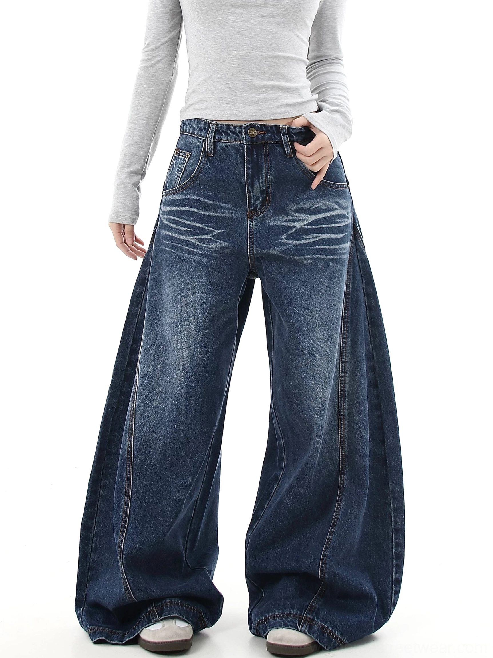 Front view of medium blue ultra-wide flare jeans with classic five-pocket construction, faded denim finish, and Korean streetwear styling