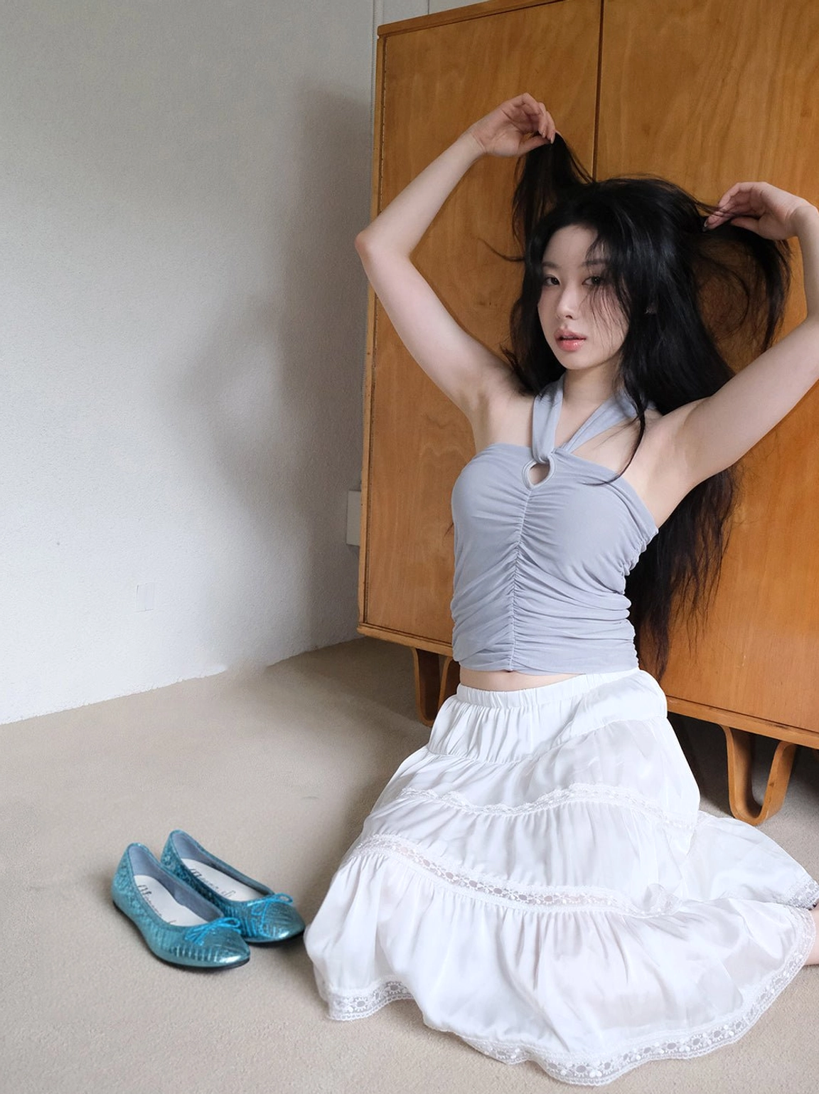 Full body outfit featuring metallic blue quilted ballet flats styled with a ruffled white skirt and contemporary Seoul fashion