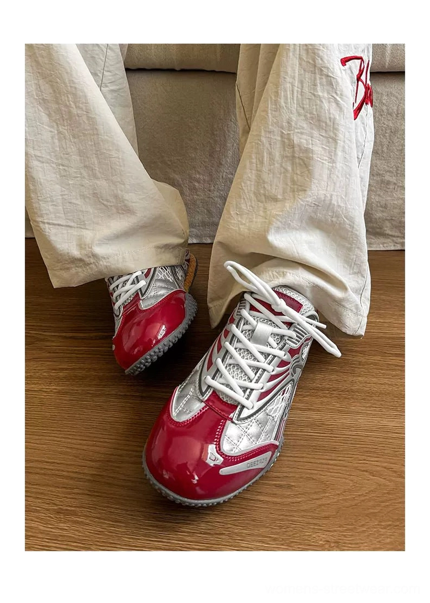 On-foot side view of red and silver heart mesh Y2K sneakers styled with loose off-white pants for a casual streetwear outfit