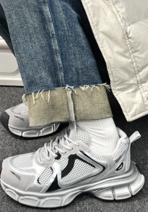 Metallic mesh retro runner sneakers worn with cropped jeans and white socks in a Korean streetwear outfit side view