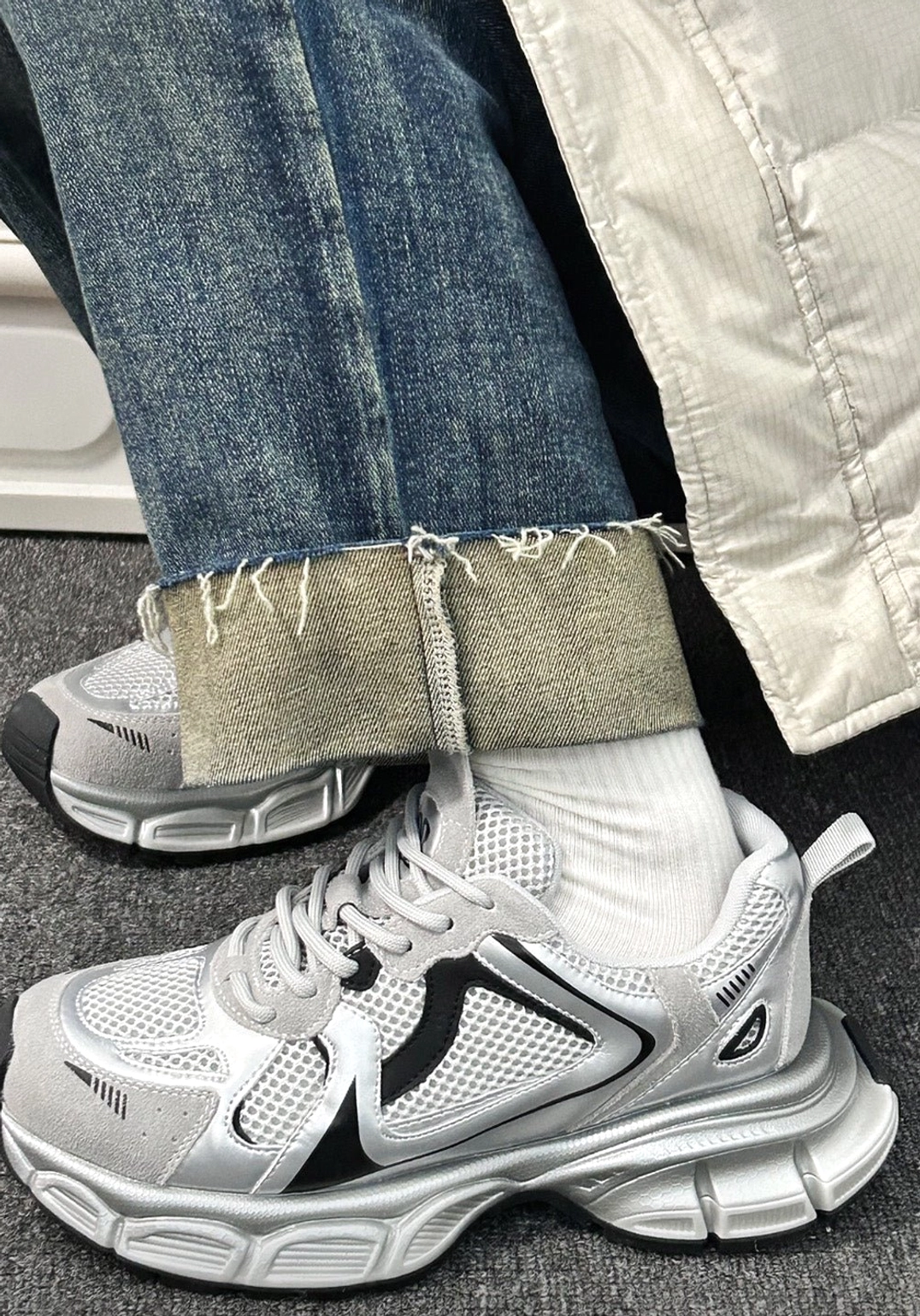 Metallic mesh retro runner sneakers worn with cropped jeans and white socks in a Korean streetwear outfit side view