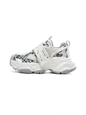 Metallic silver mesh tech runner sneaker in a left front three-quarter view with chunky sculpted outsole, breathable grid upper, reflective overlays, lace-up closure, and adjustable strap