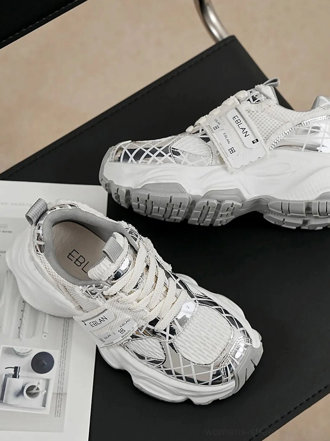 Metallic silver mesh tech runner sneakers shown from above with breathable mesh panels, reflective synthetic overlays, lace-up front, cushioned insole, and futuristic streetwear styling