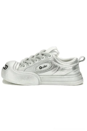 Metallic silver platform canvas sneaker shown from the side with chunky sole, textured toe bumper, heel pull tab, and streetwear design