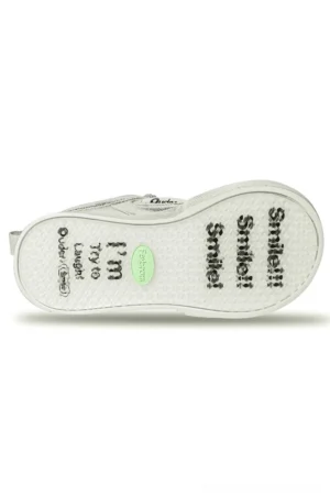 Top view of removable insole from metallic silver platform sneakers with printed slogan, textured surface, and sneaker construction details