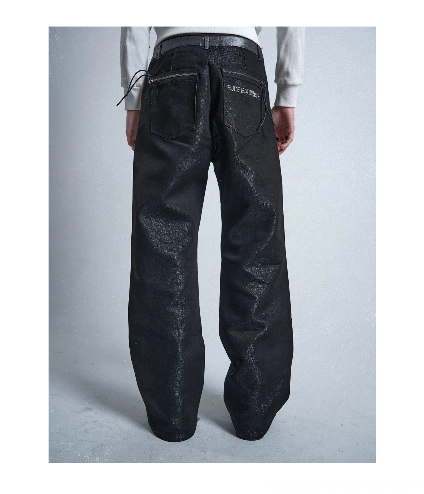 Rear view of black silver yarn raw straight jeans showing double back pockets and wide straight leg silhouette