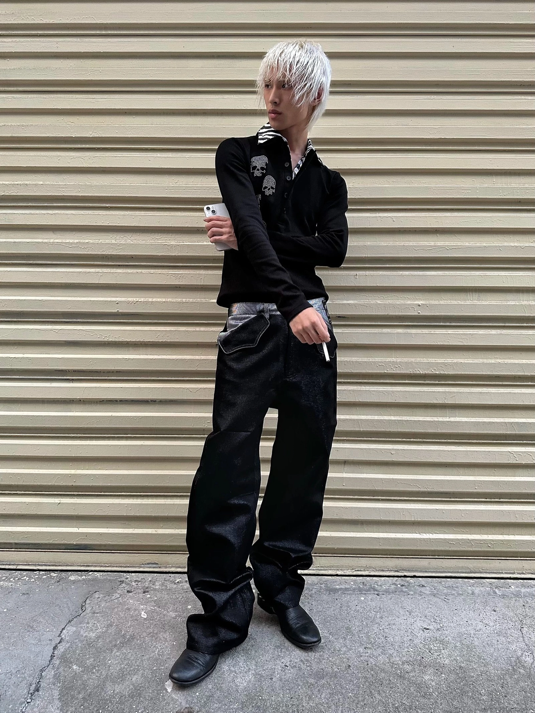 Full front view of loose black silver yarn straight leg jeans styled with a fitted black long sleeve top