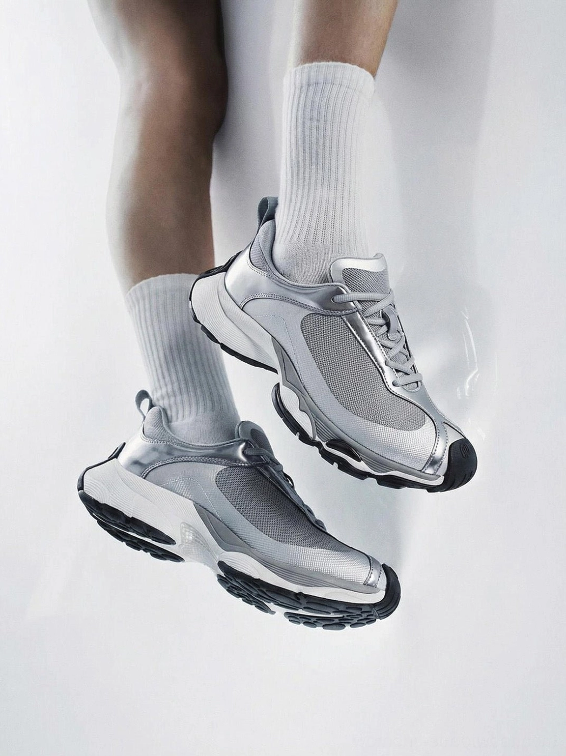 Metallic split-toe technical runner sneaker viewed from above on foot, highlighting the laces, mesh upper, split toe, and chunky outsole