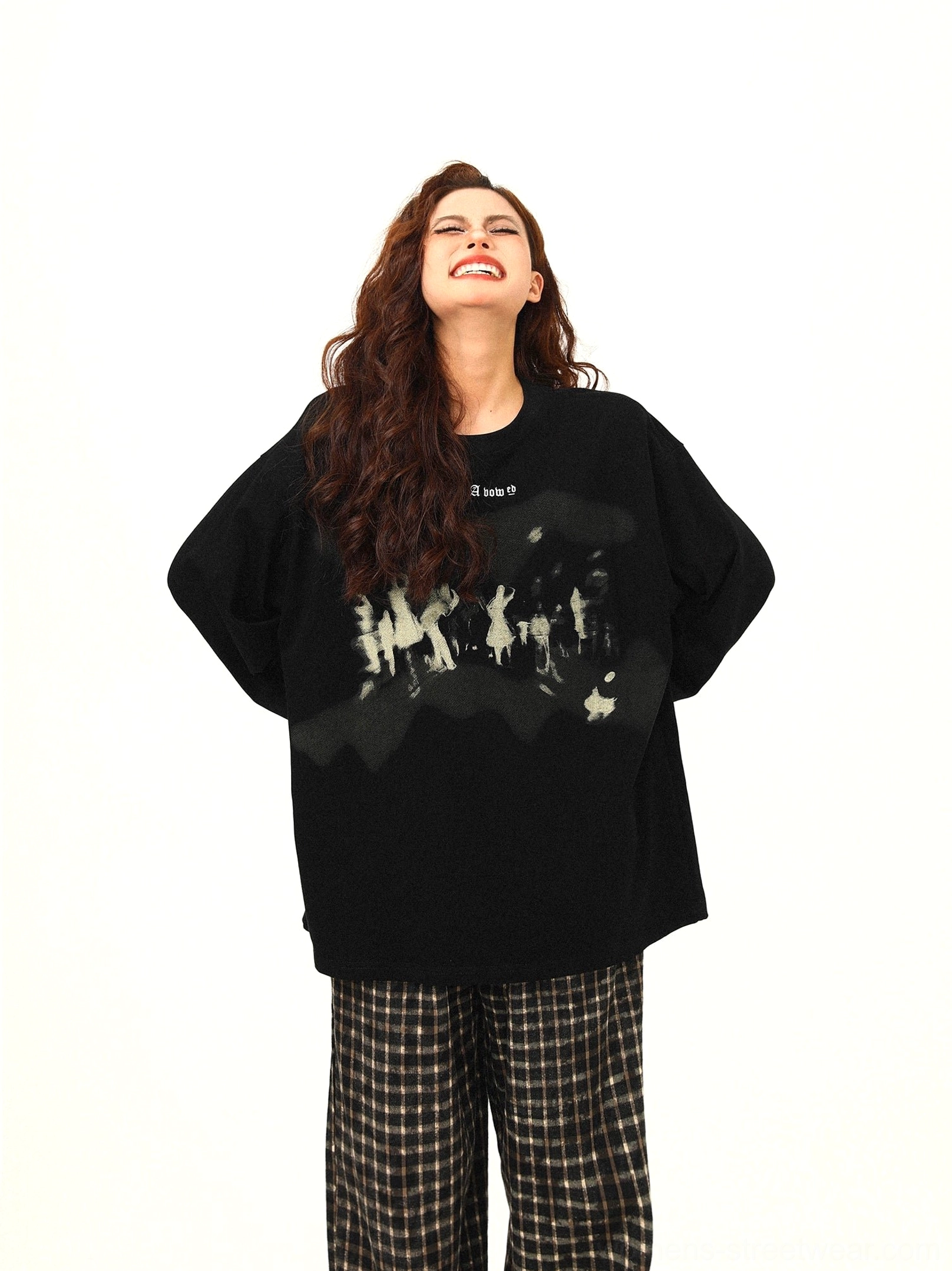 Low-angle front view of black oversized graphic crewneck sweatshirt with faded crowd silhouette artwork and long sleeves