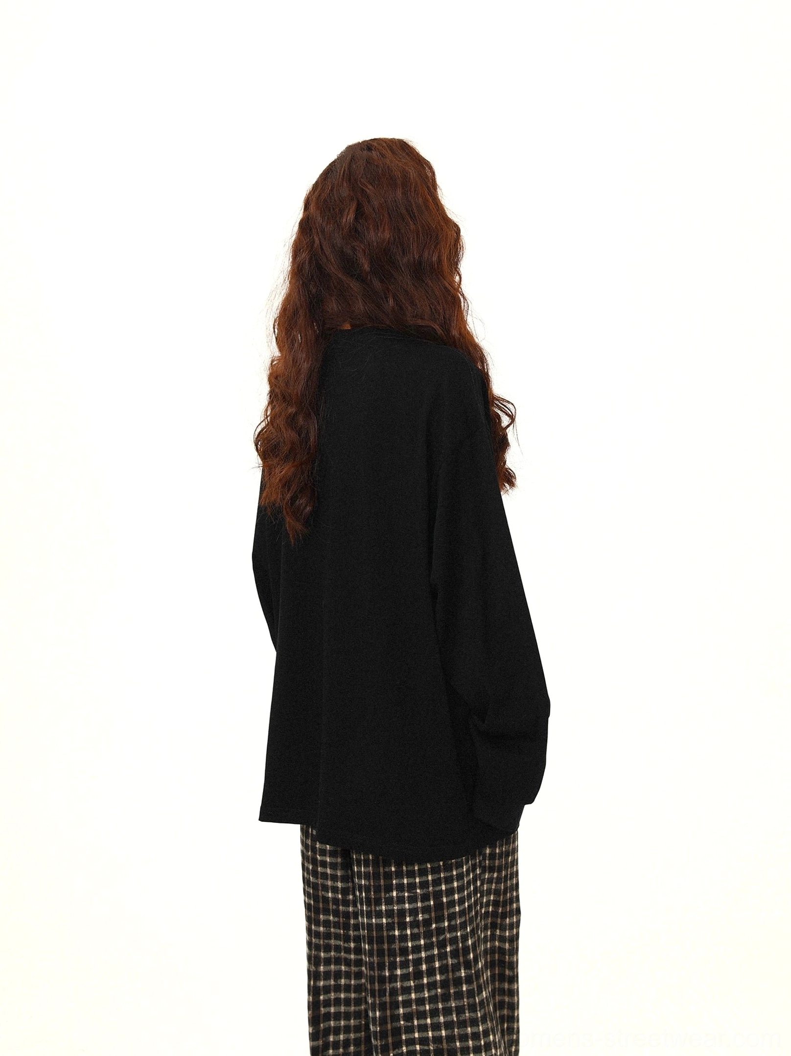Full back view of black oversized sweatshirt showing the clean solid back and relaxed modern streetwear silhouette