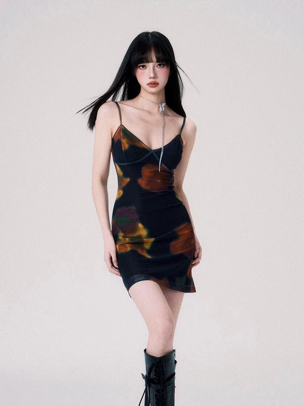 Midnight Ember floral mesh slip mini dress worn with black knee-high boots in a front full-body studio view