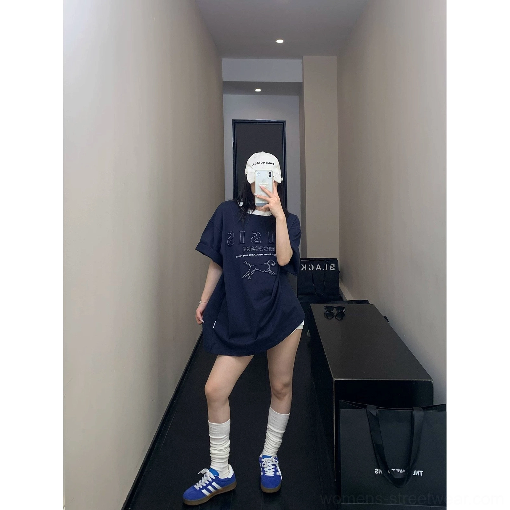 Casual navy blue oversized hound graphic T-shirt styled with a baseball cap for everyday streetwear