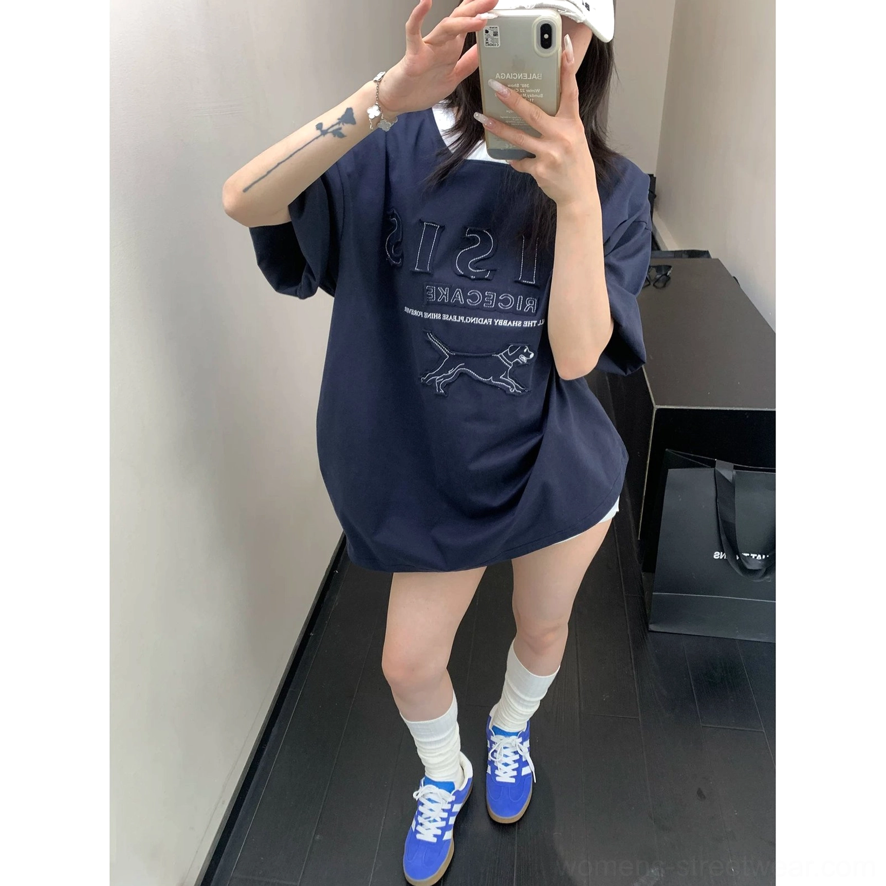 Full length outfit featuring navy blue oversized hound streetwear T-shirt with white socks and retro sneakers