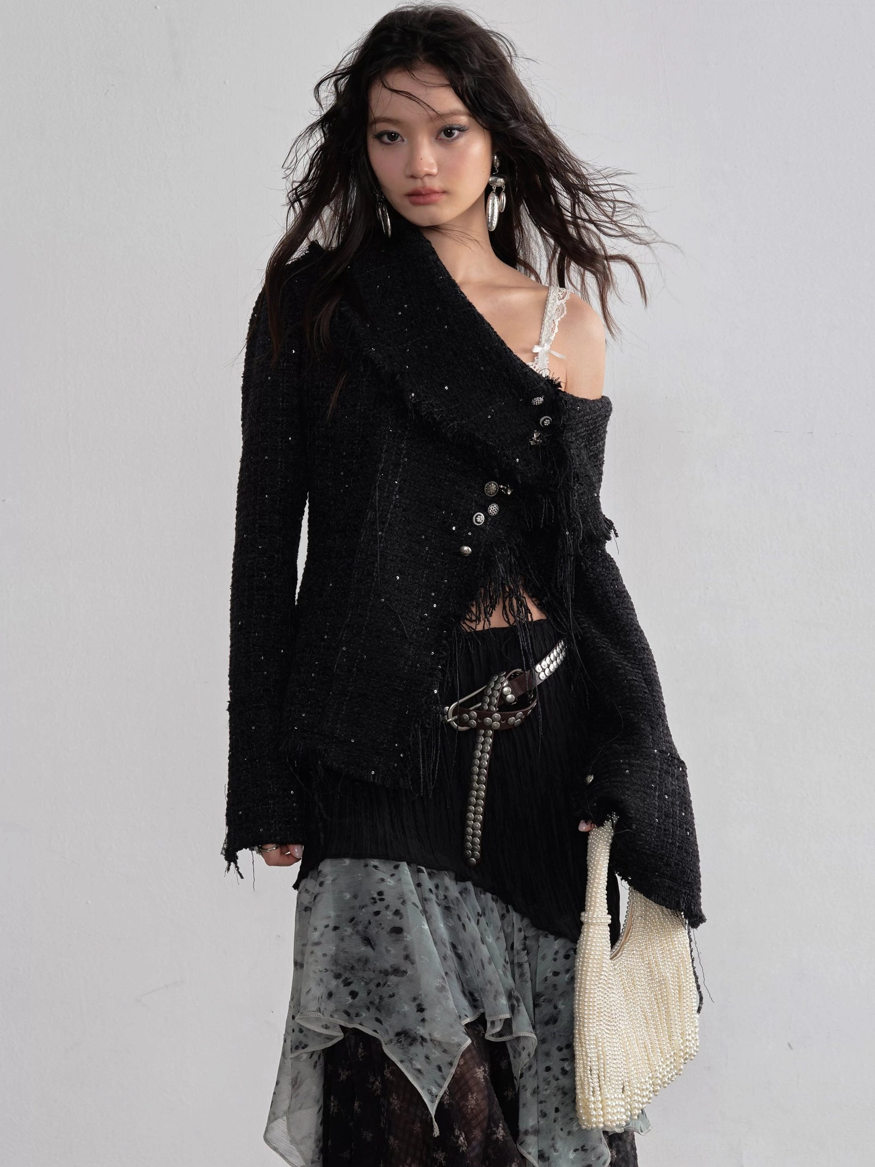 Close front outfit view highlighting the high rise waistband and tiered asymmetrical ruffle layers of the black chiffon maxi skirt