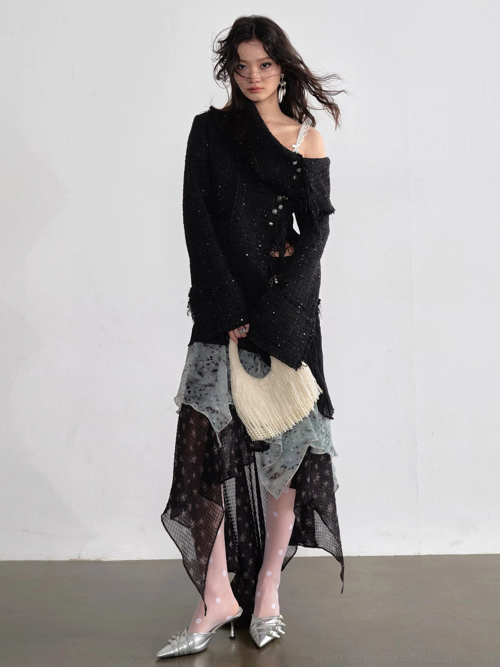 Three quarter front view of black asymmetrical ruffle maxi skirt with smoky blue grey chiffon layers and handkerchief hem