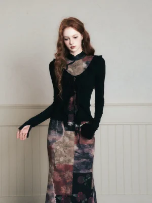 Black fitted tie-front ribbed knit cardigan top styled with a romantic patchwork floral maxi skirt in a vintage interior