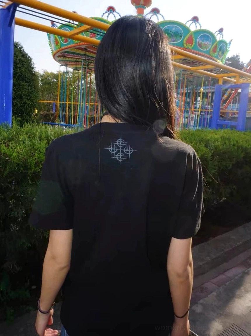 Back view of black Midnight Outcome crew neck T-shirt showing the subtle geometric gothic emblem on the upper back