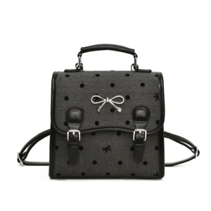 Midnight polka bow sweet academy satchel backpack in dark grey with black polka dots, bow print, black faux leather trim and silver buckle hardware front view