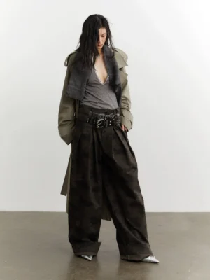 Front view of military green camo streetwear trousers styled with a deep v-neck top and oversized trench coat