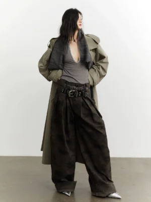 Back three-quarter view of military green camouflage wide-leg streetwear trousers with pleated high waist on a female model