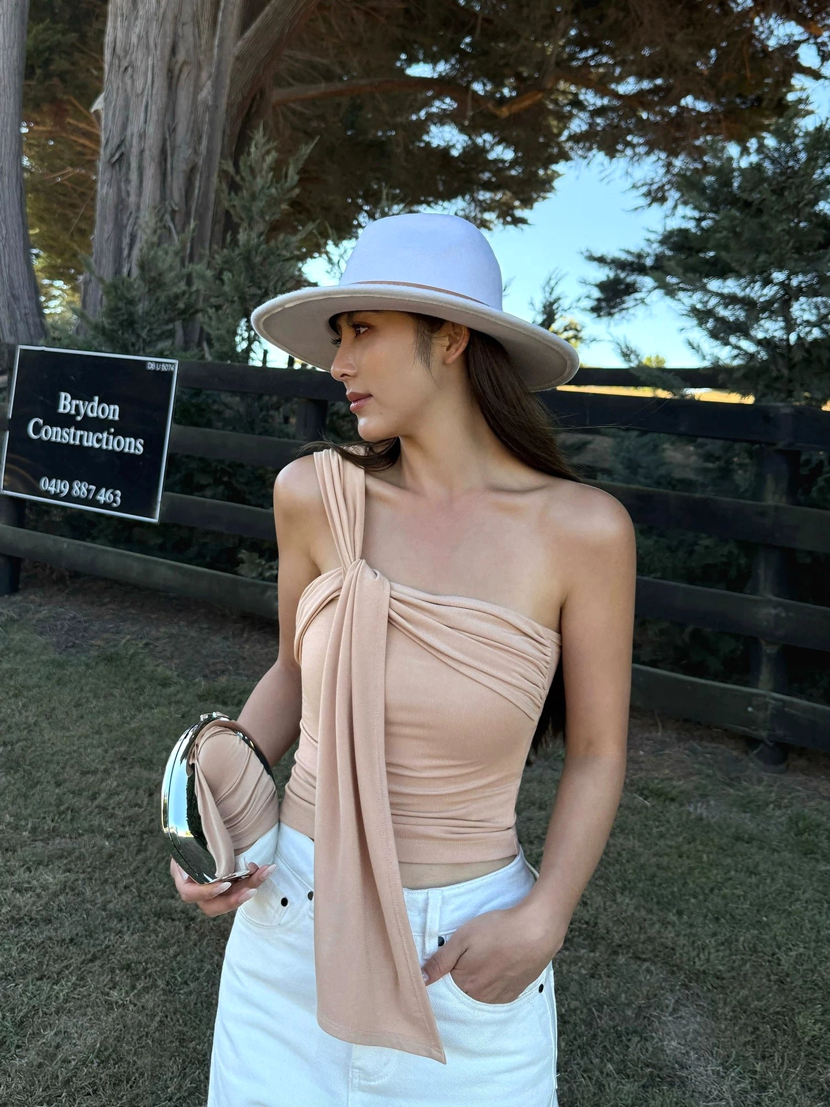 Milk Tea beige asymmetric draped one-shoulder crop top with soft stretch knit and elegant sash detail