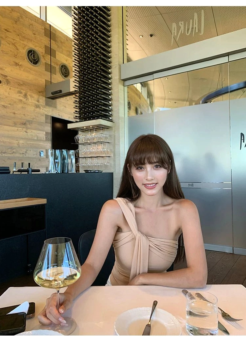 Milk Tea beige asymmetric one-shoulder top with soft draped fabric and statement shoulder tie styled for dinner