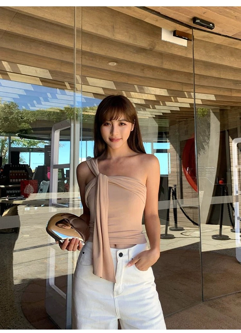 Milk Tea beige asymmetric draped crop top paired with white wide-leg pants for an elegant casual streetwear outfit
