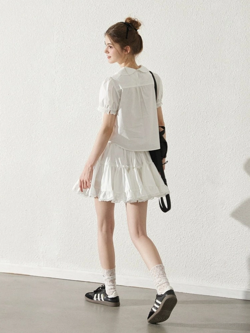 Milk white short sleeve blouse and ruffle mini skirt Korean fashion outfit back view with black crossbody bag