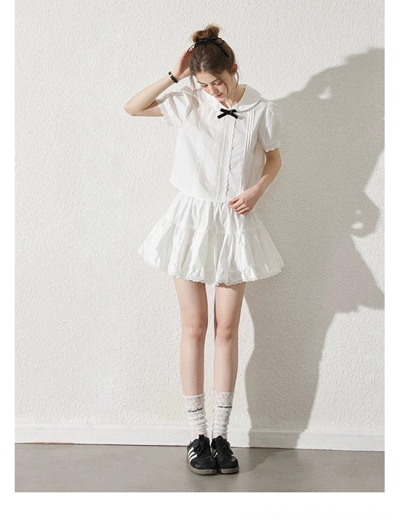 Milk white short sleeve blouse with black bow Peter Pan collar and ruffle mini skirt front standing view