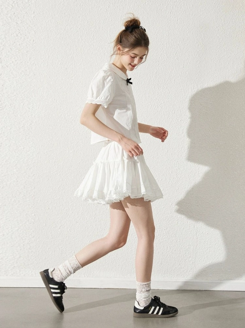 Milk white Peter Pan collar short sleeve blouse and ruffle mini skirt in Korean streetwear walking side view