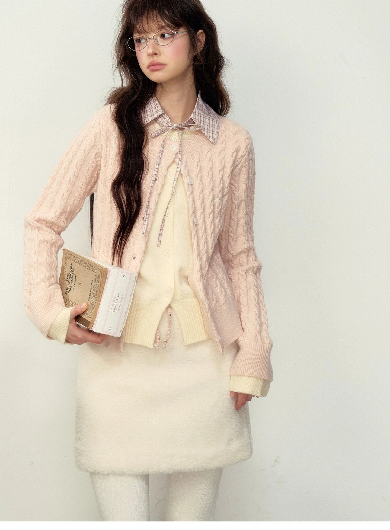 Milky pink cable knit preppy cardigan front close-up styled with a plaid collar and glasses for Korean campus fashion