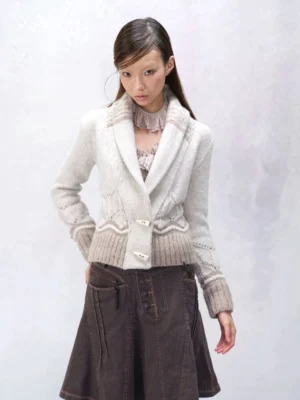 Model wearing a milky white and beige cropped knit blazer cardigan with Fair Isle shawl collar, toggle button fastening, ribbed cuffs, and vintage Korean streetwear styling