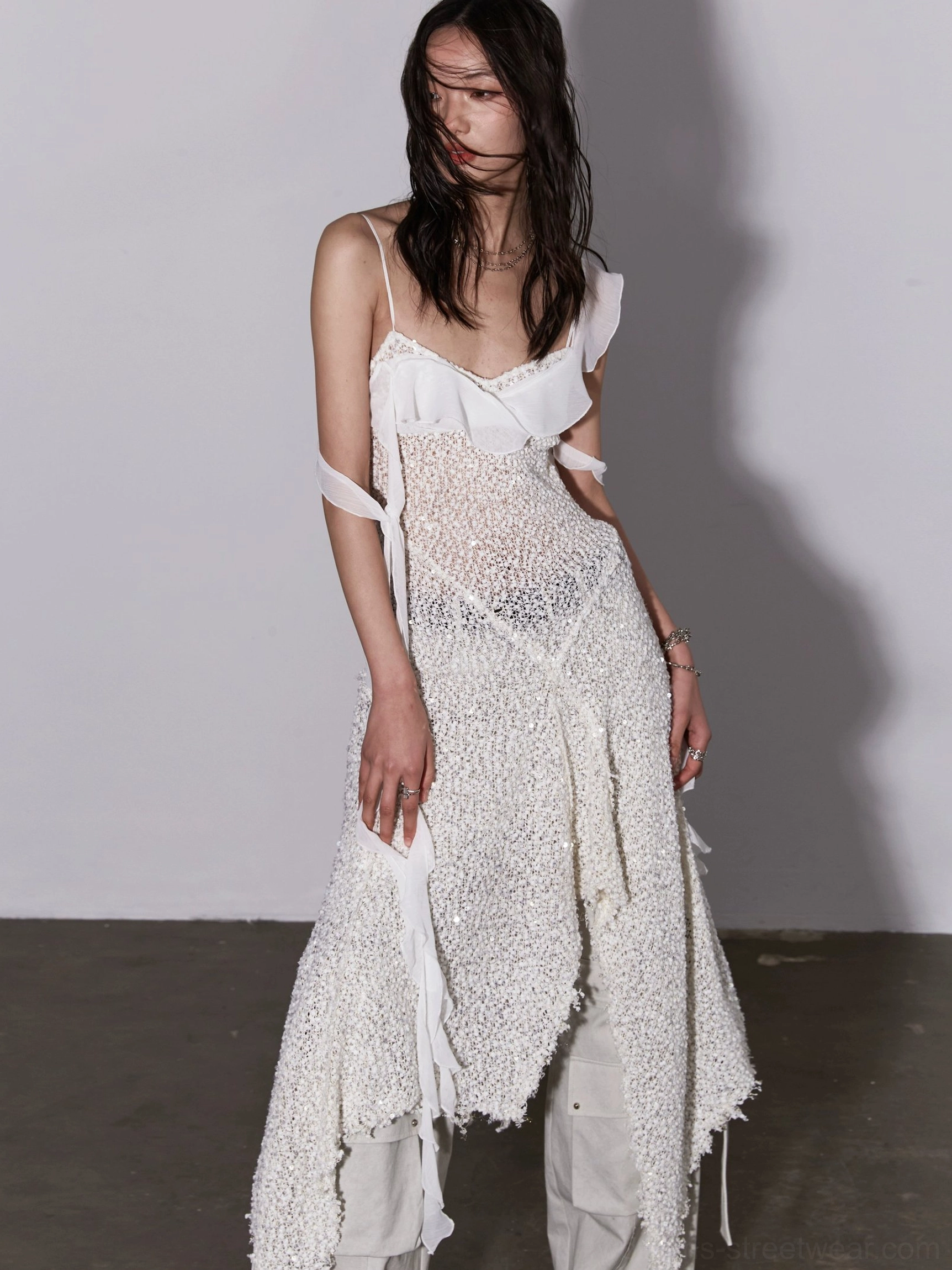 Milky white sequin mesh asymmetric layered slip dress front three quarter view with ruffled neckline and flowing strap details