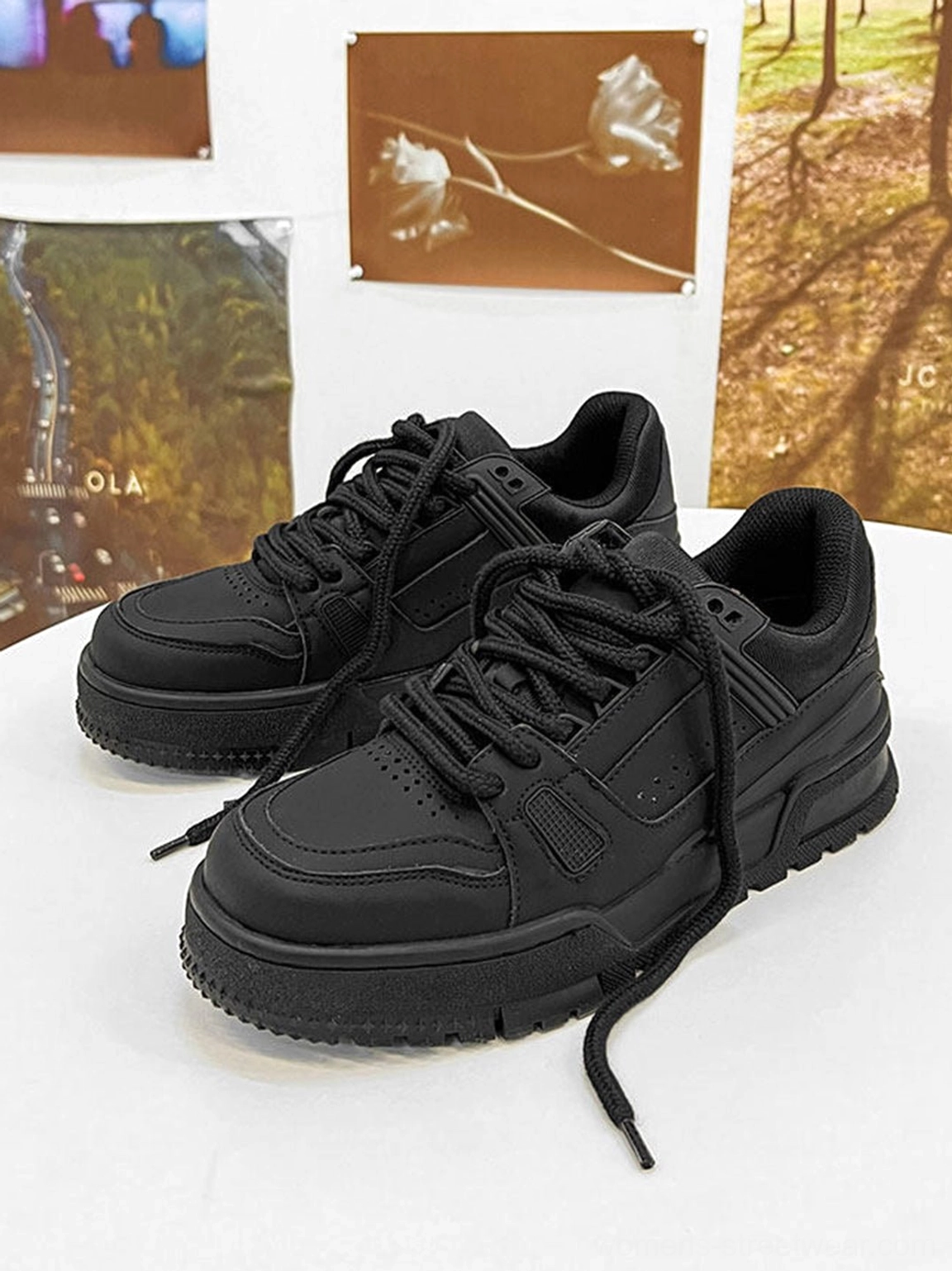 Minimal black chunky platform sneakers product image highlighting the clean matte upper and bold rounded streetwear sole