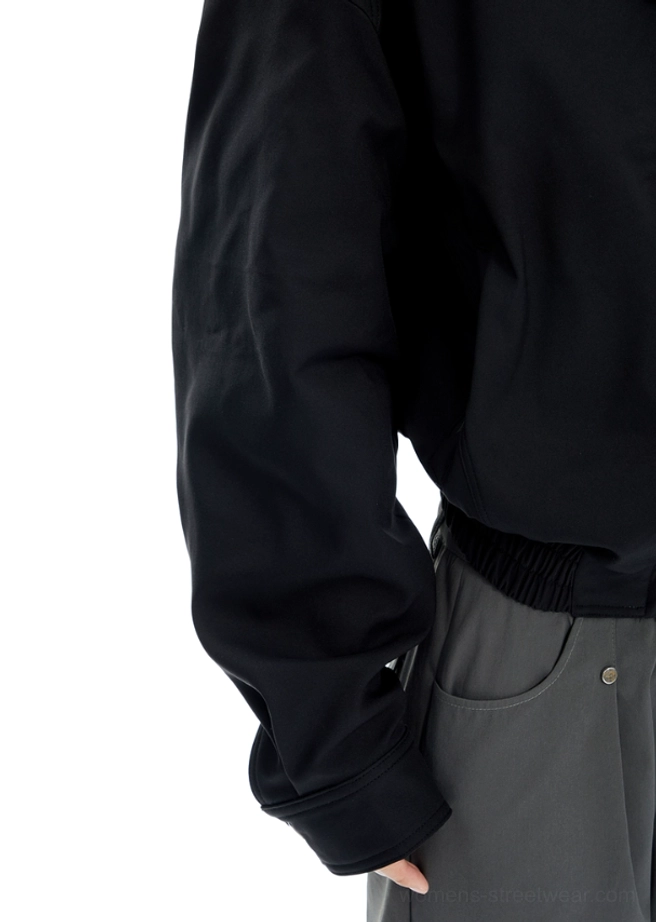 Contemporary high-collar bomber jacket with compact cropped waist, oversized sleeves, ribbed trims, and clean minimalist styling